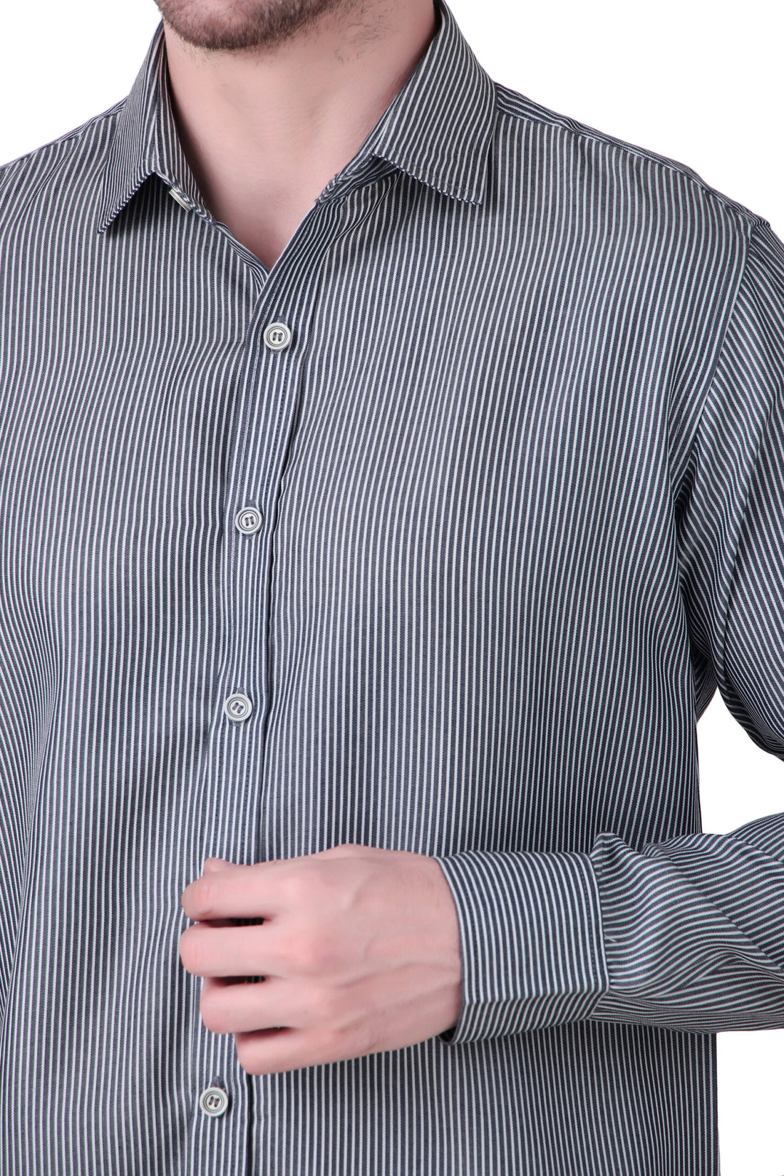 A man wearing a gray textured long-sleeve button-up shirt and light blue jeans, standing against a plain white background.