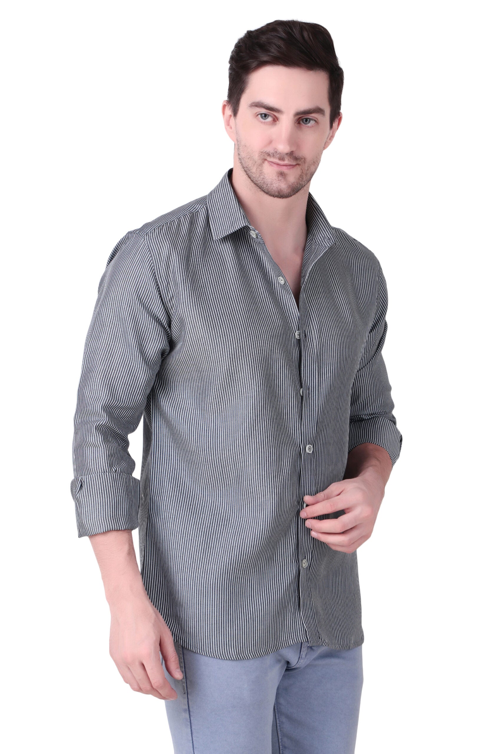 A man wearing a gray textured long-sleeve button-up shirt and light blue jeans, standing against a plain white background.